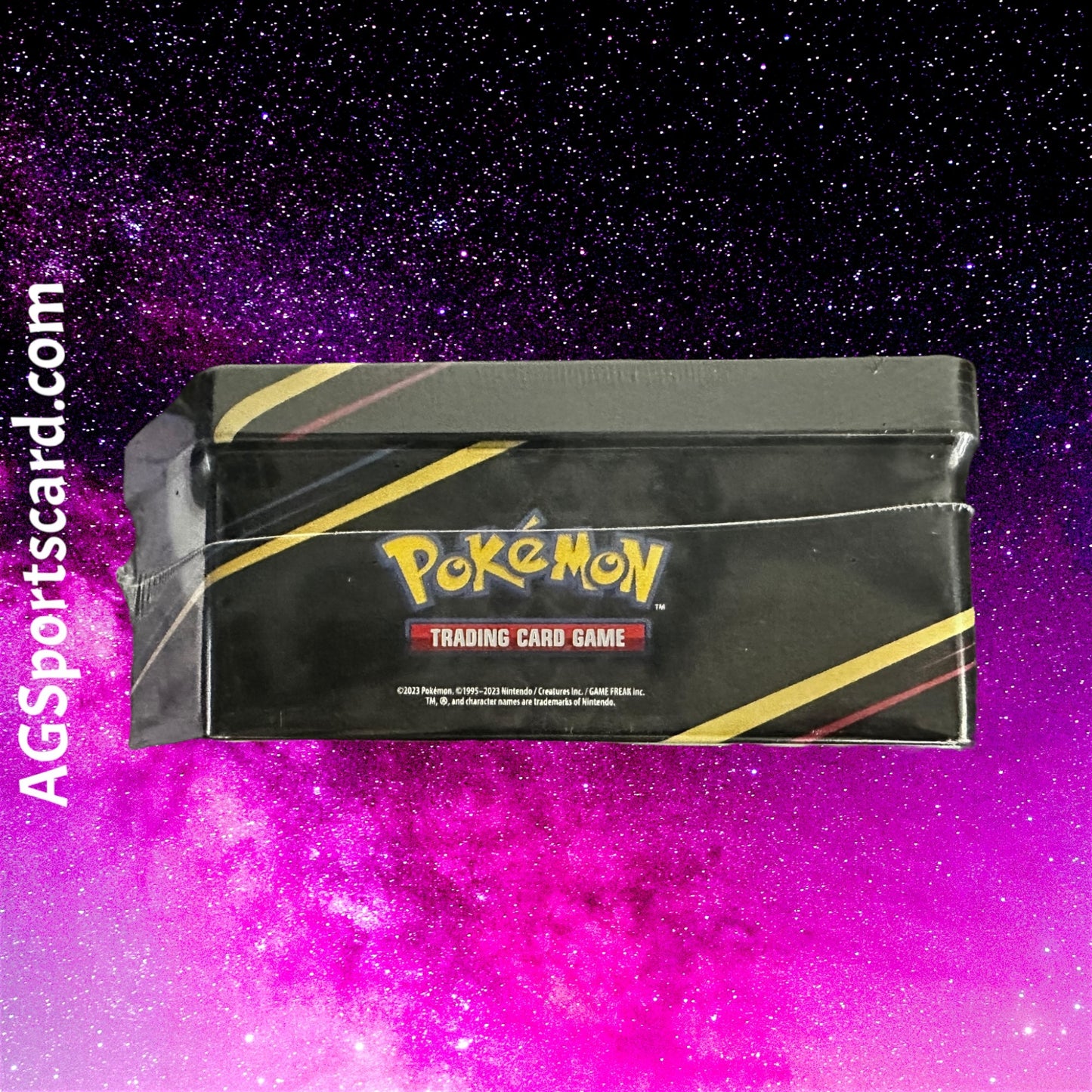 a box of pokemon trading card game in front of a galaxy background